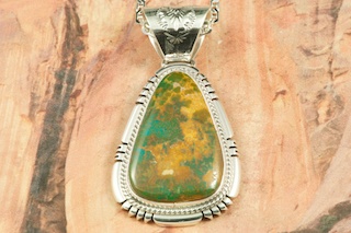 Genuine Crow Springs Turquoise set in Sterling Silver Pendant. Created by Navajo Artist Freddy Charley. The Crow Springs Mine is located near Tonopah, Nevada. Free 18 inch Sterling Silver Chain with purchase. 